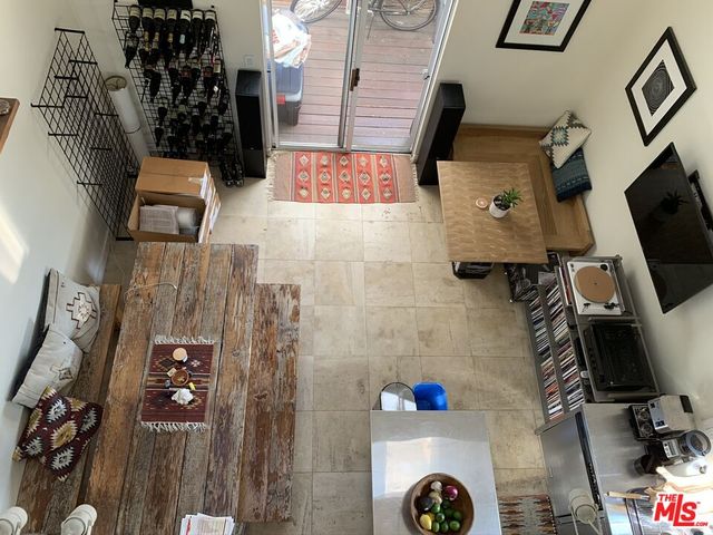 a view of backyard with wheel chair potted plants and large tree