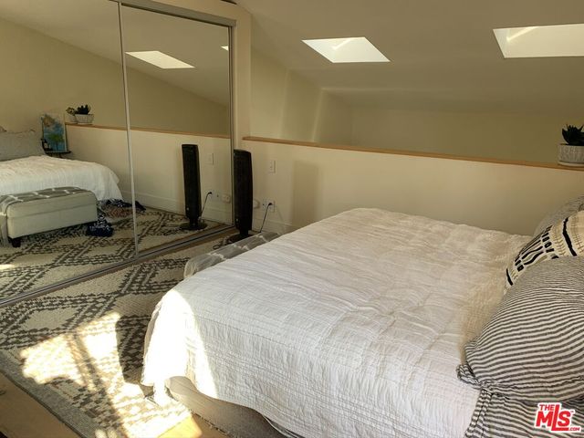 a view of a balcony with chairs potted plants