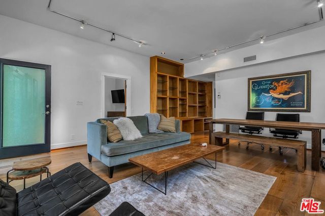 a living room with furniture pool table and a flat screen tv
