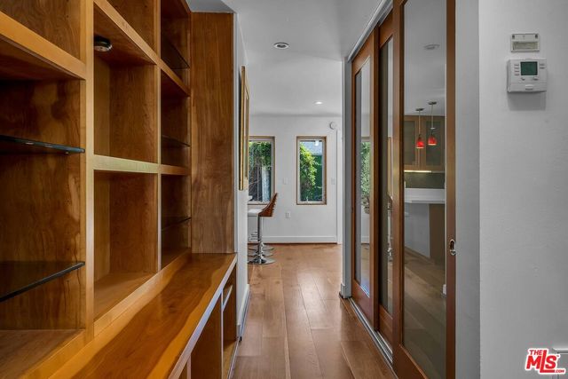 a view of a hallway with wooden floor and staircase