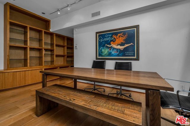 a living room with furniture a rug and paintings on the wall