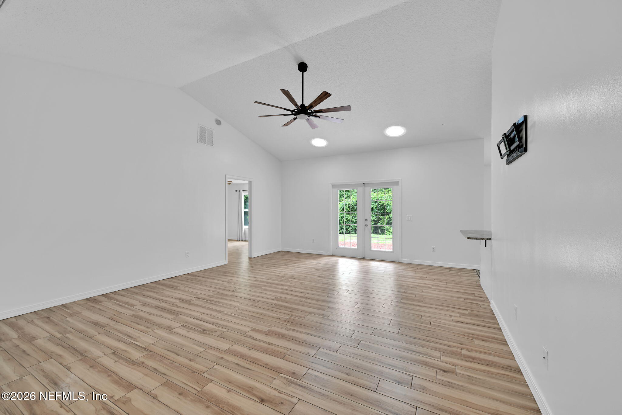 1110 Woodlawn Road, Unit D St. Augustine, FL 32084 - Photo 17 of 40 wooden floor in an empty room with a window