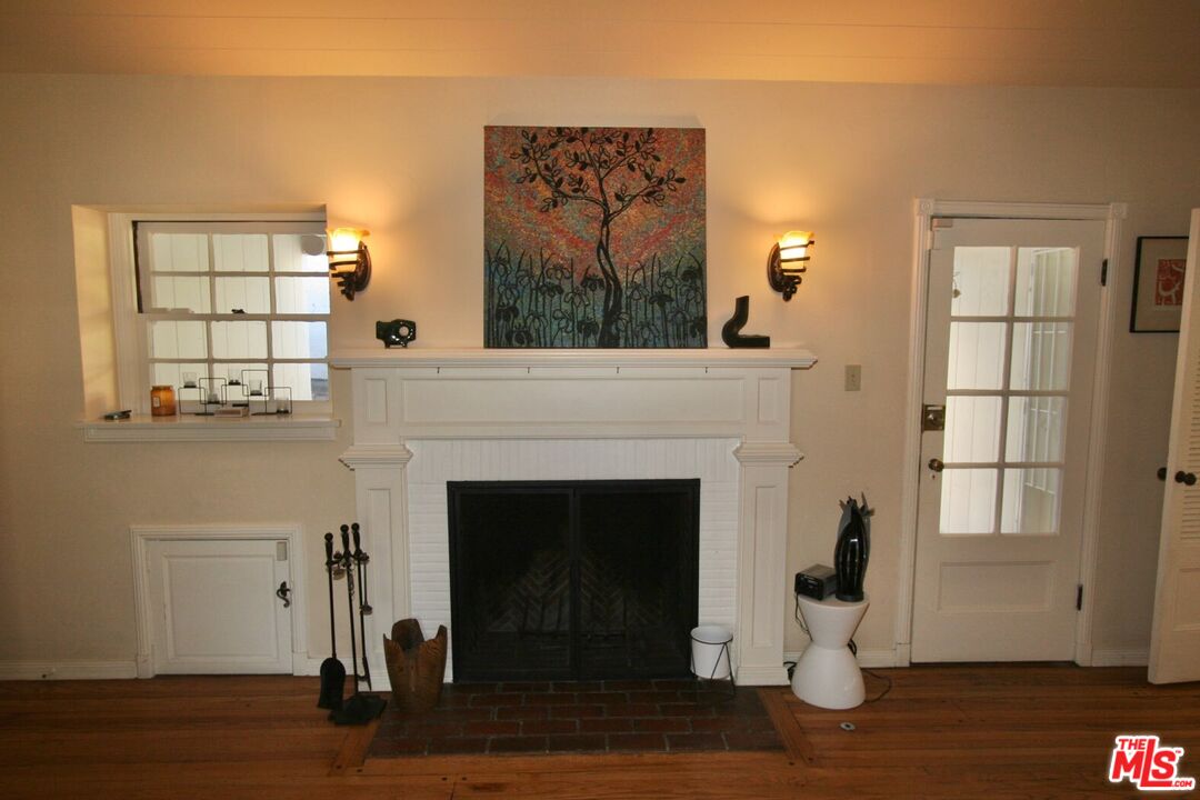 10317 Lauriston Avenue Los Angeles, CA 90025 - Photo 12 of 52 a living room with a fireplace and wooden floor