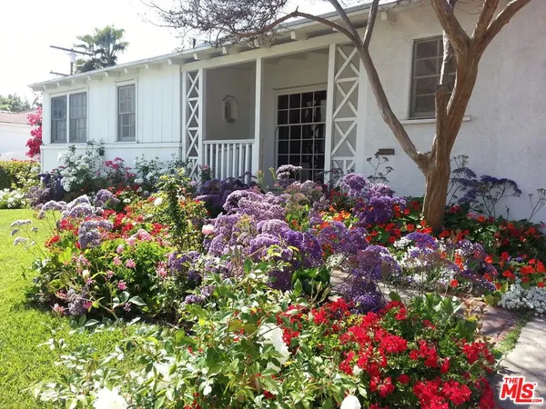 a bunch of flowers are in front of house