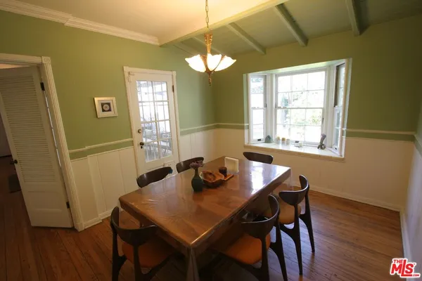 a view of a room that has a couch and chandelier