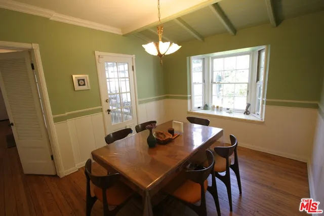 a view of a room that has a couch and chandelier