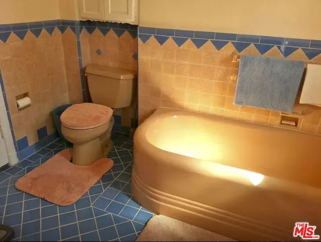 a bedroom with two beds and painted walls