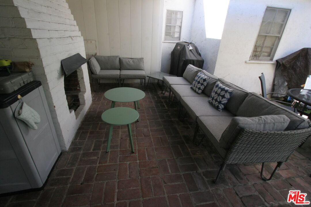 10317 Lauriston Avenue Los Angeles, CA 90025 - Photo 49 of 52 a living room with furniture a flat screen tv and a window