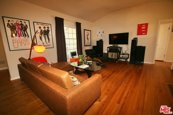 a living room with furniture fireplace and flat screen tv