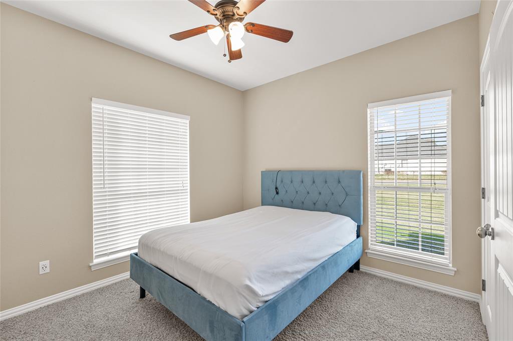 10264 Farmington Road Van Alstyne, TX 75495 - Photo 22 of 39 a large bed sitting in a bedroom next to a window