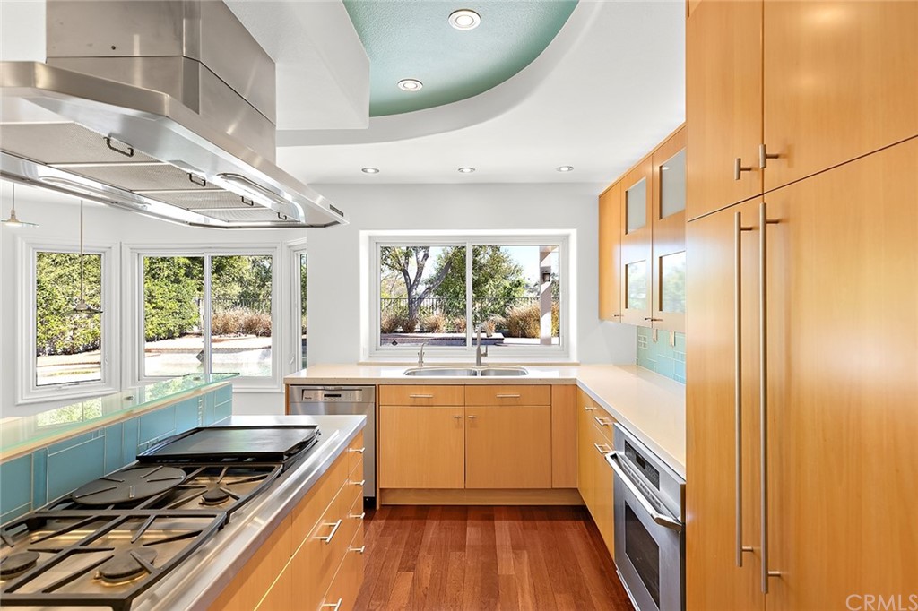 34 New Haven Laguna Niguel, CA 92677 - Photo 12 of 35 a kitchen with wooden floor and a stove top oven
