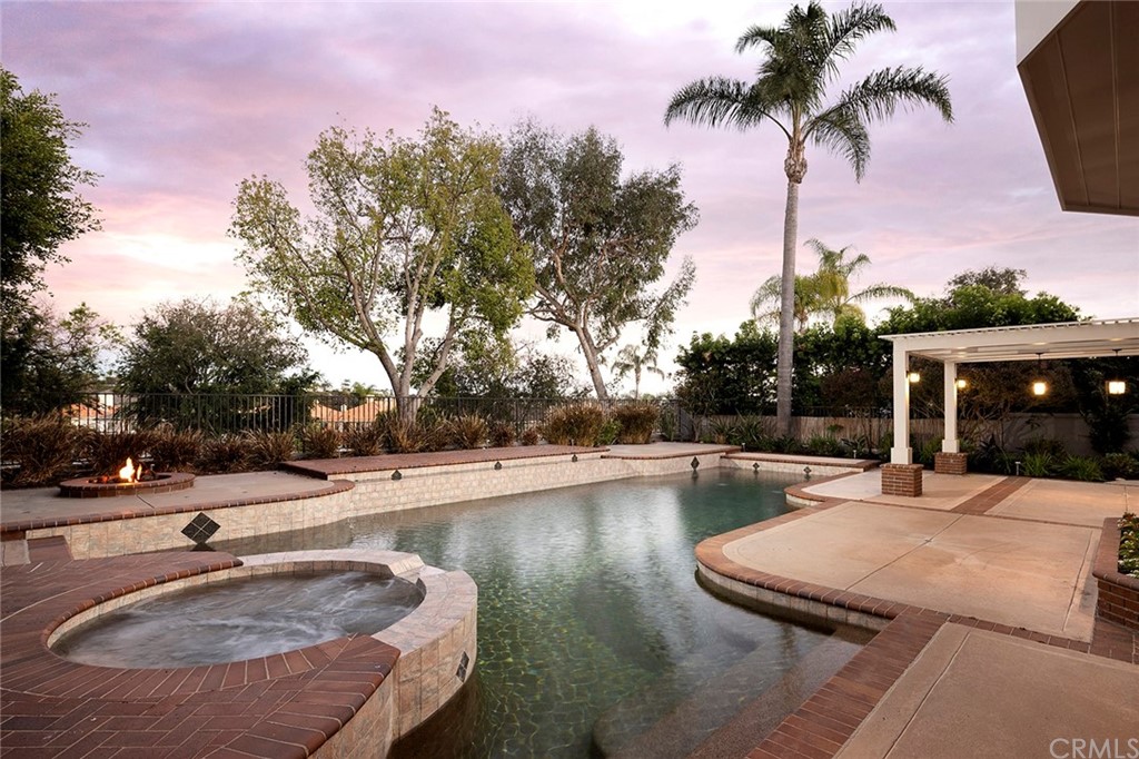 34 New Haven Laguna Niguel, CA 92677 - Photo 31 of 35 a swimming pool with outdoor seating and house in the background