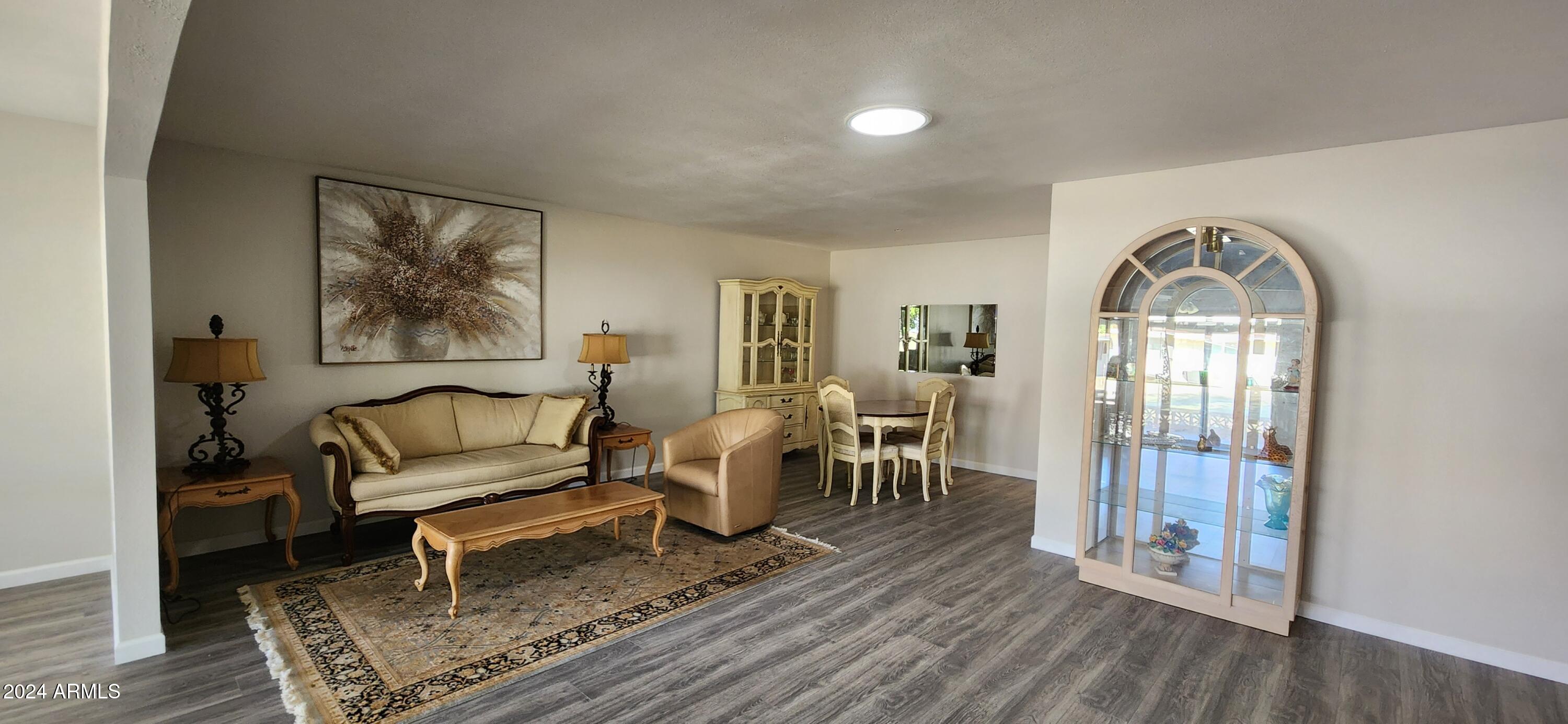 10338 West Kingswood Circle Sun City, AZ 85351 - Photo 11 of 24 a living room with furniture and a fireplace