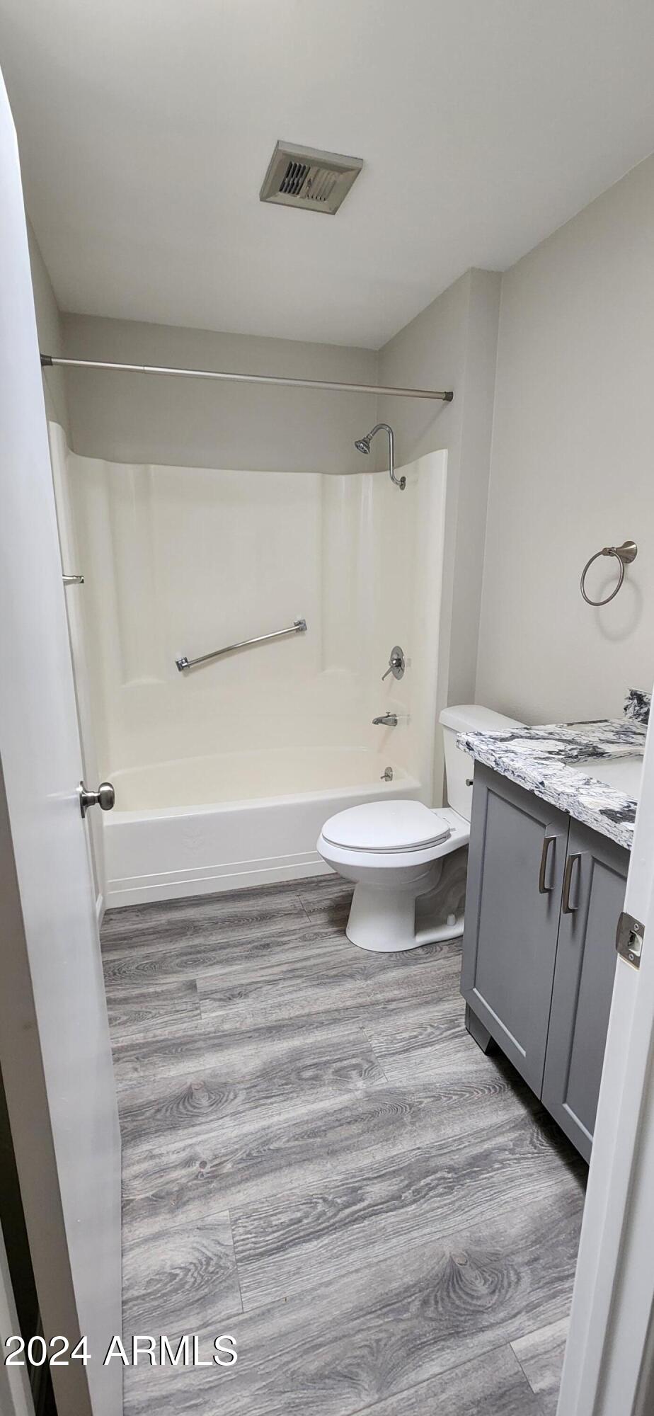 10338 West Kingswood Circle Sun City, AZ 85351 - Photo 19 of 24 a bathroom with a granite countertop sink toilet and shower