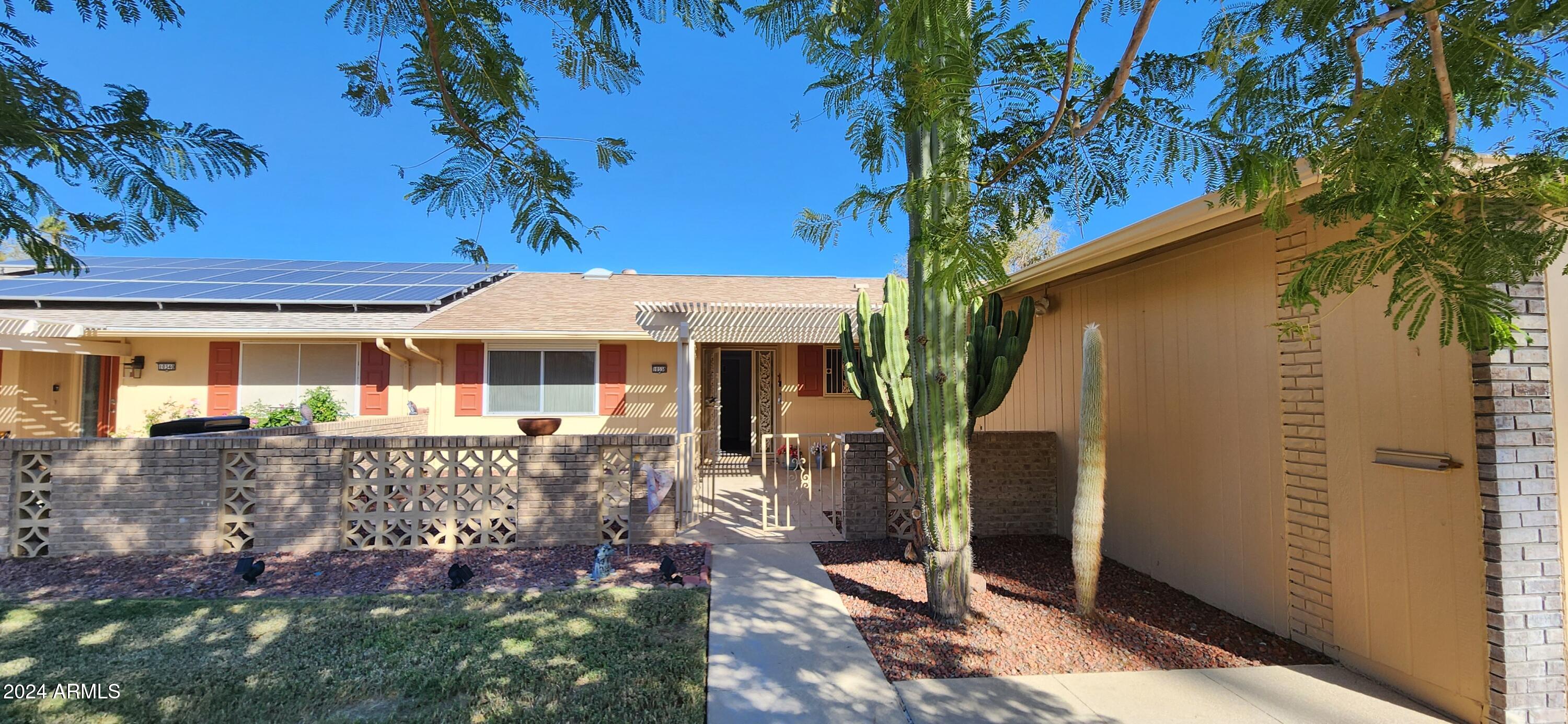 10338 West Kingswood Circle Sun City, AZ 85351 - Photo 20 of 24 a front view of a house with garden