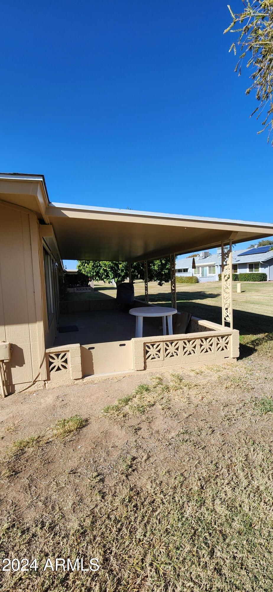 10338 West Kingswood Circle Sun City, AZ 85351 - Photo 21 of 24 a view of car parked in front of a house