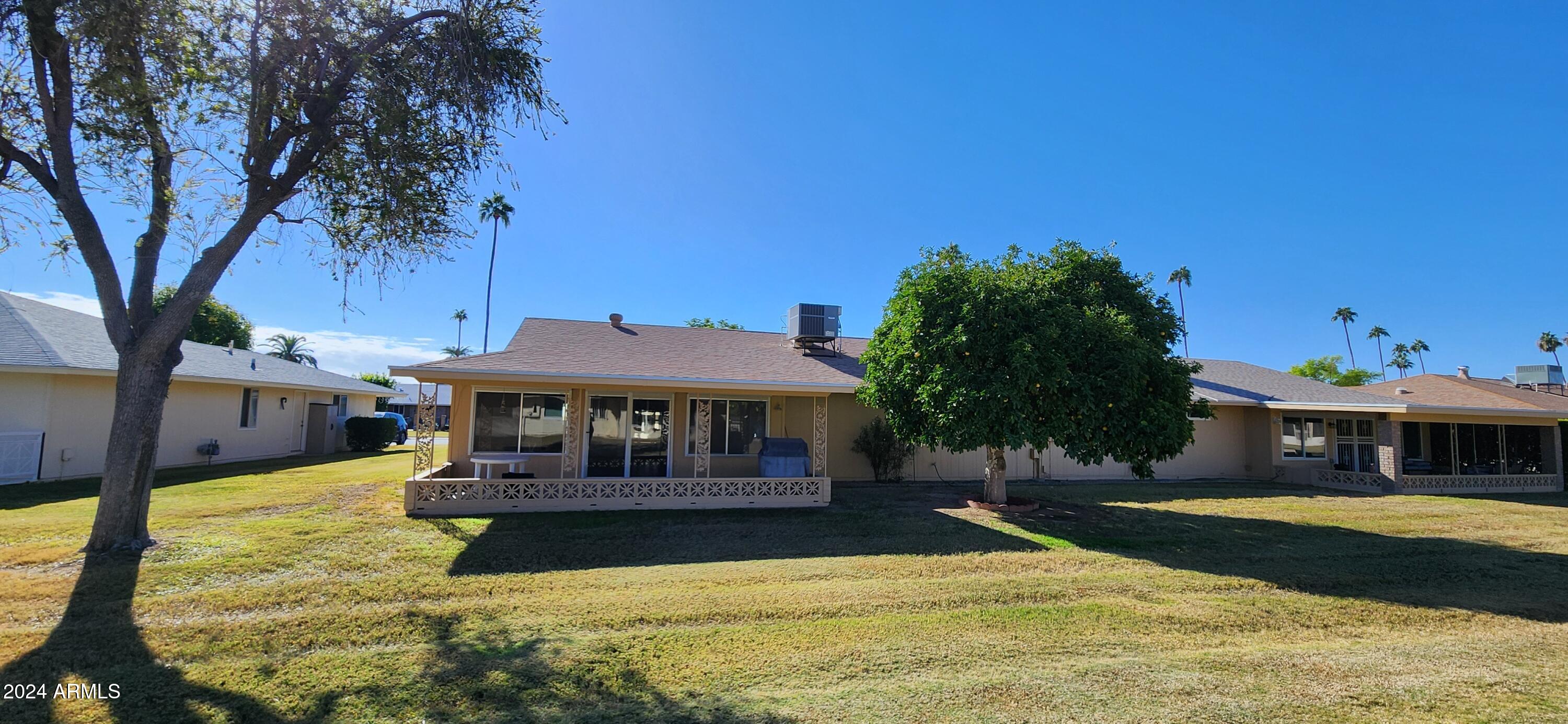 10338 West Kingswood Circle Sun City, AZ 85351 - Photo 23 of 24 a view of house with swimming pool and a yard