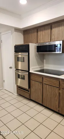 a kitchen with stainless steel appliances a refrigerator and cabinets