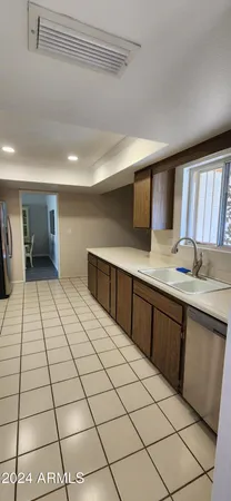 a large white kitchen with a sink and cabinets