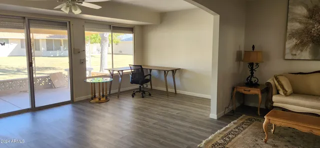 a living room with furniture and a wooden floor