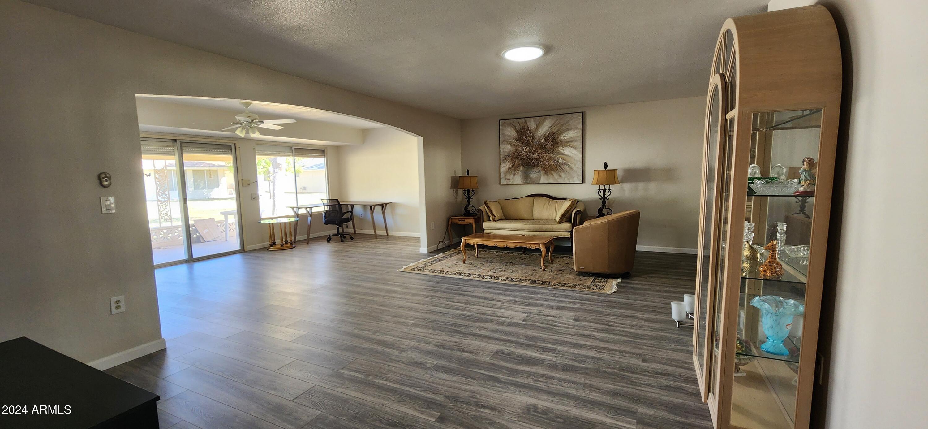 10338 West Kingswood Circle Sun City, AZ 85351 - Photo 9 of 24 a living room with furniture and a wooden floor