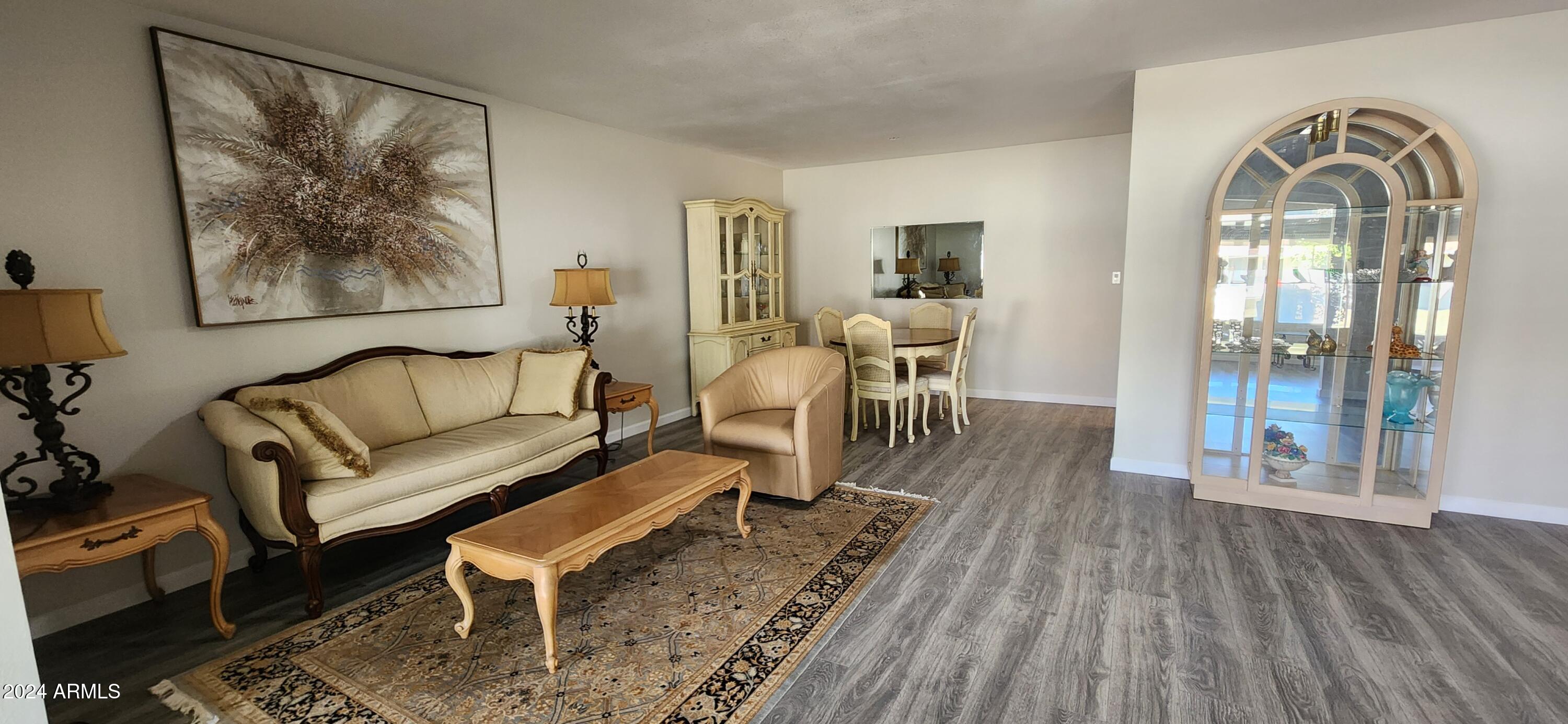 10338 West Kingswood Circle Sun City, AZ 85351 - Photo 10 of 24 a living room with furniture and a wooden floor