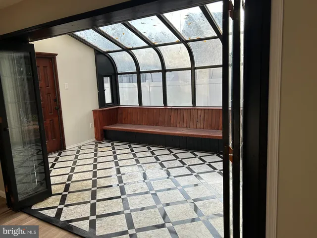 a view of a livingroom with wooden floor and a fireplace