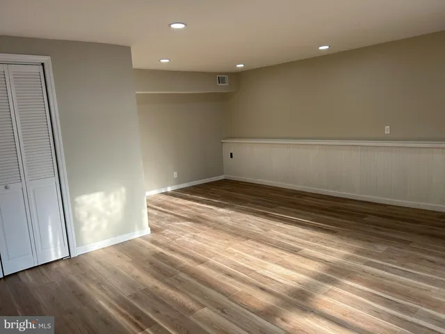 a view of a room with wooden floor and stairs