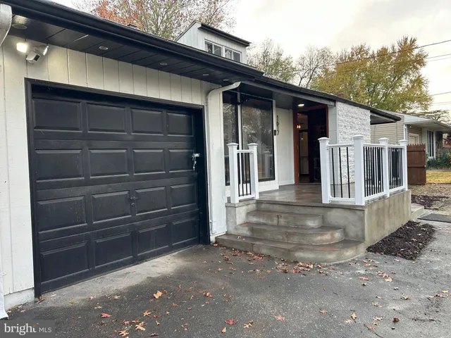 a view of a house with a door and wooden walls