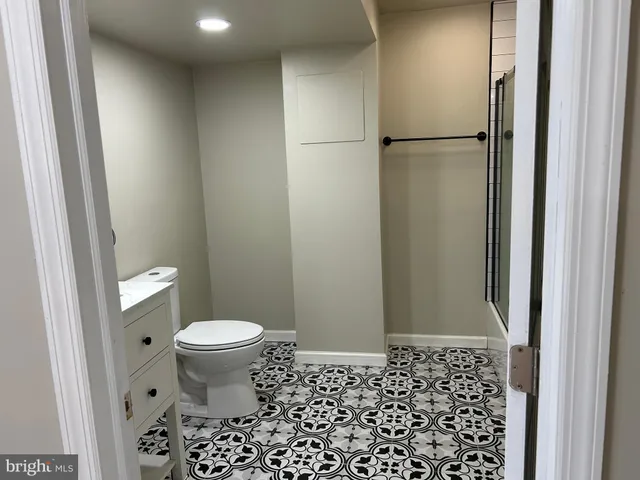 a bathroom with a shower and a sink