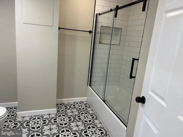 a view of a small space with wooden floor and a window