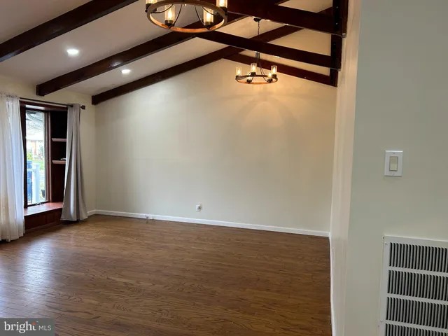 an empty room with wooden floor