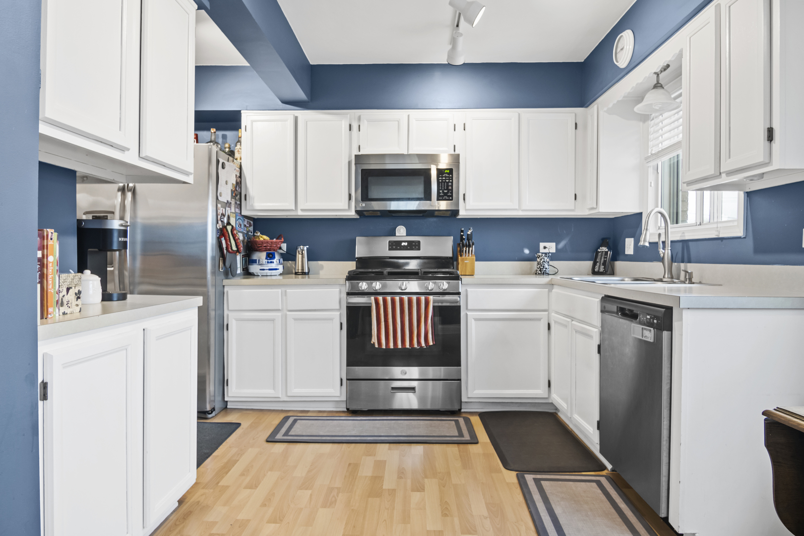 1258 Chalet Road, Unit 301 Naperville, IL 60563 - Photo 6 of 15 a kitchen with a sink a stove and cabinets