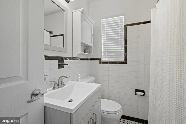 a bathroom with a sink toilet and vanity