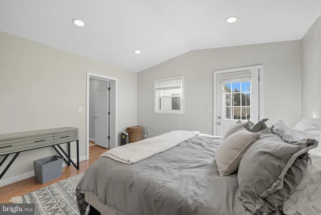 a bed sitting in a bedroom next to a window