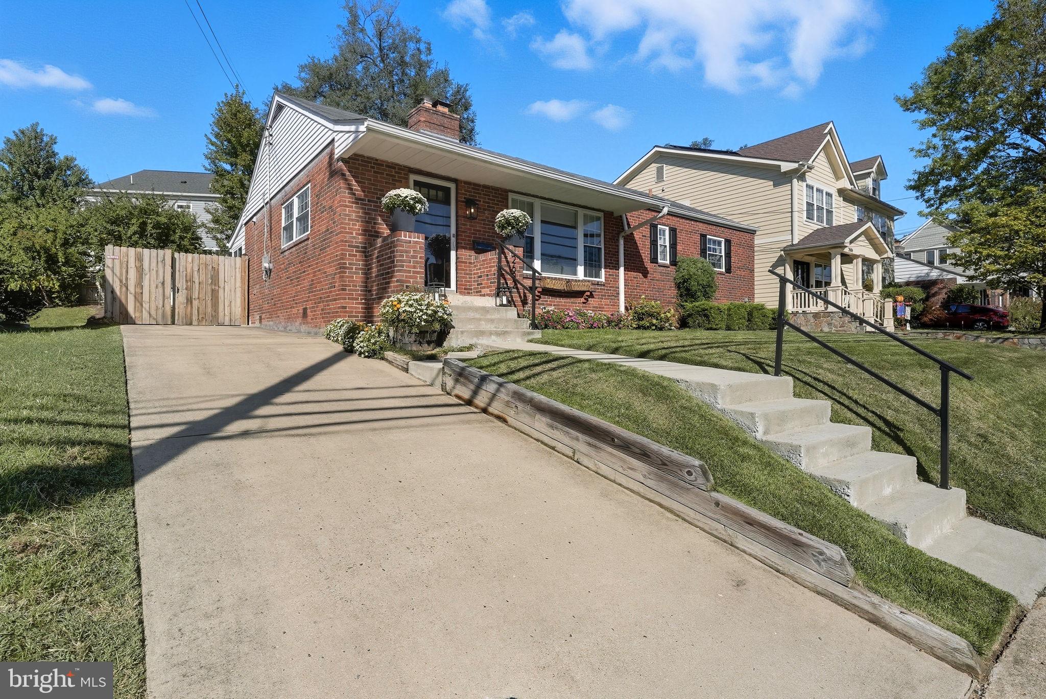 2632 North Sycamore Street Arlington, VA 22207 - Photo 2 of 26 a view of a white house next to a yard with big trees