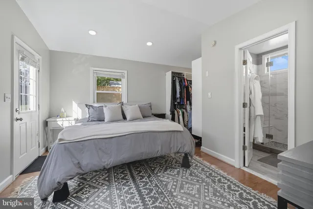 a spacious bedroom with a bed and a rug