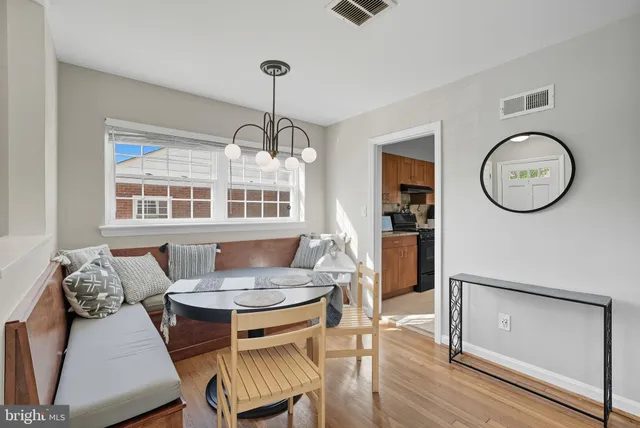 a dining room with furniture a window and wooden floor