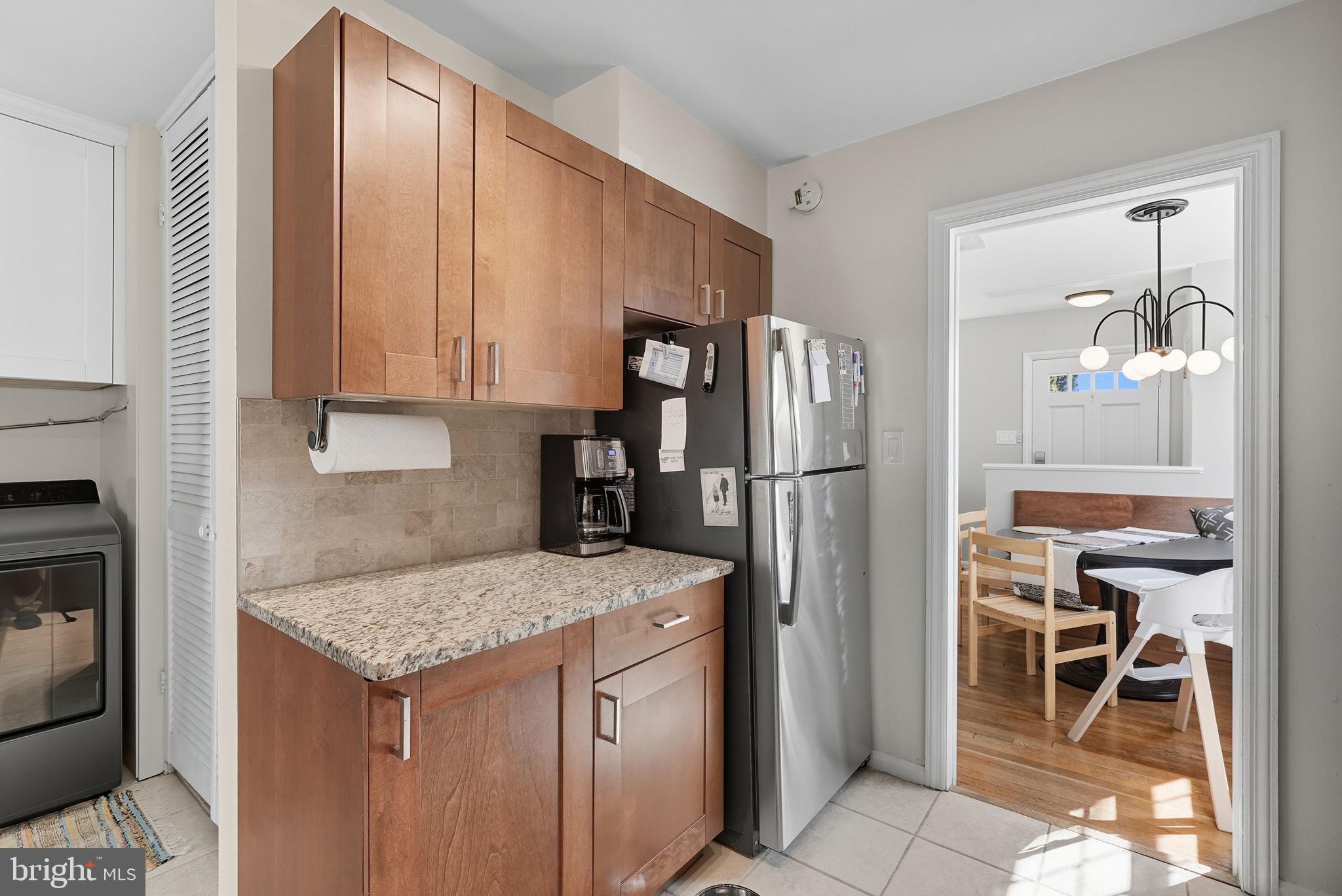 2632 North Sycamore Street Arlington, VA 22207 - Photo 10 of 26 a kitchen with a refrigerator a table and chairs in it