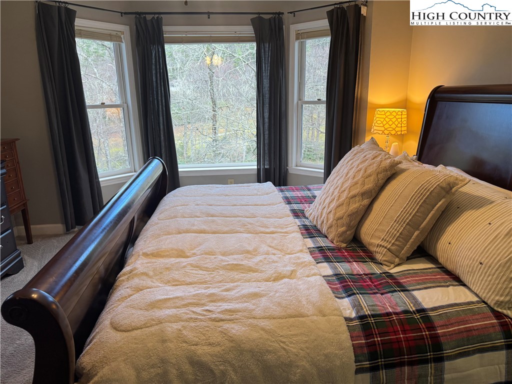 387 Tarry Acres Circle Blowing Rock, NC 28605 - Photo 23 of 41 a bedroom with a bed and a window