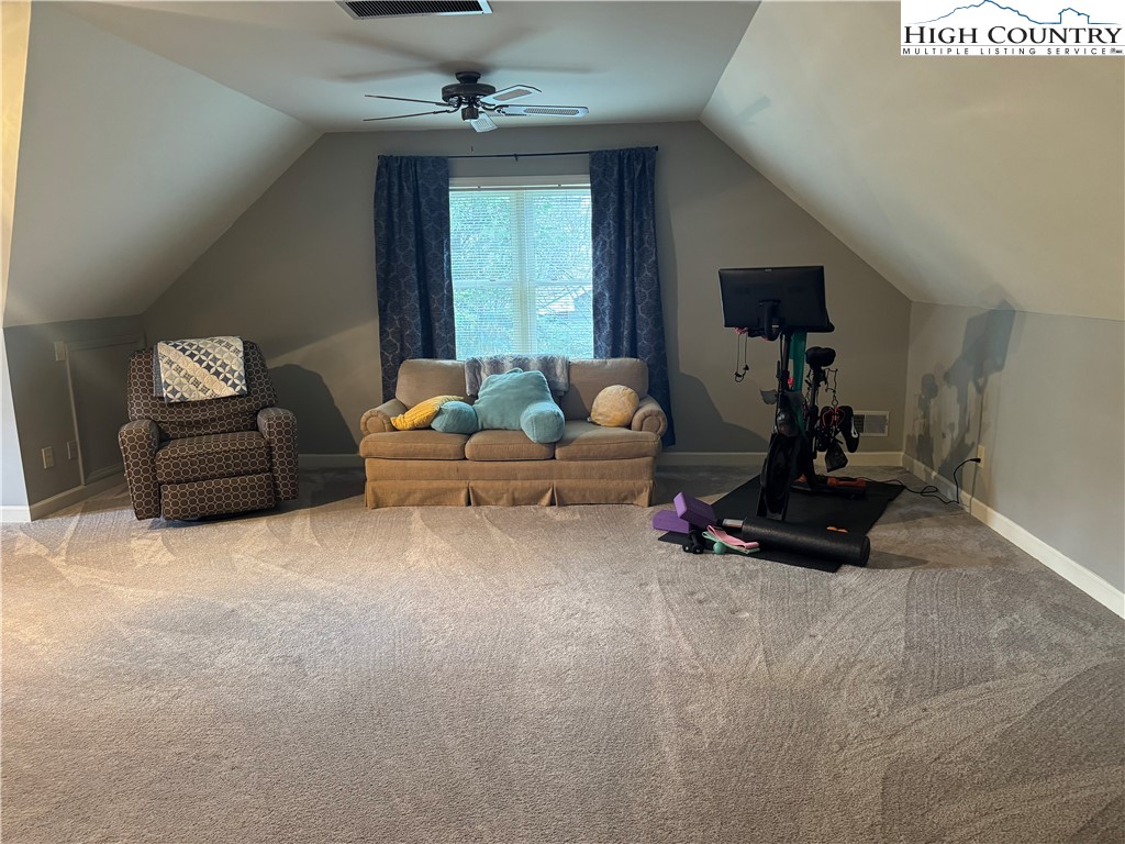 387 Tarry Acres Circle Blowing Rock, NC 28605 - Photo 31 of 41 a living room with furniture a window and a chandelier