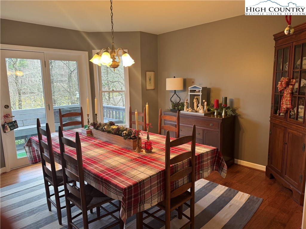 387 Tarry Acres Circle Blowing Rock, NC 28605 - Photo 10 of 41 a dining room with furniture a chandelier and wooden floor