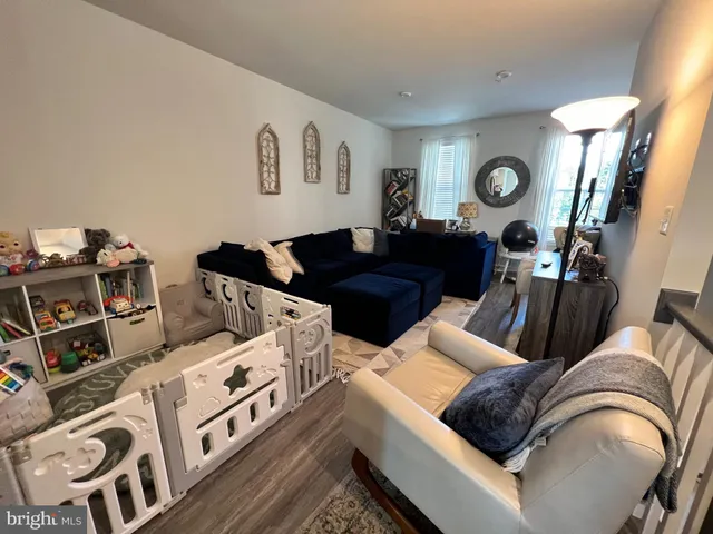 a living room with furniture and a mirror