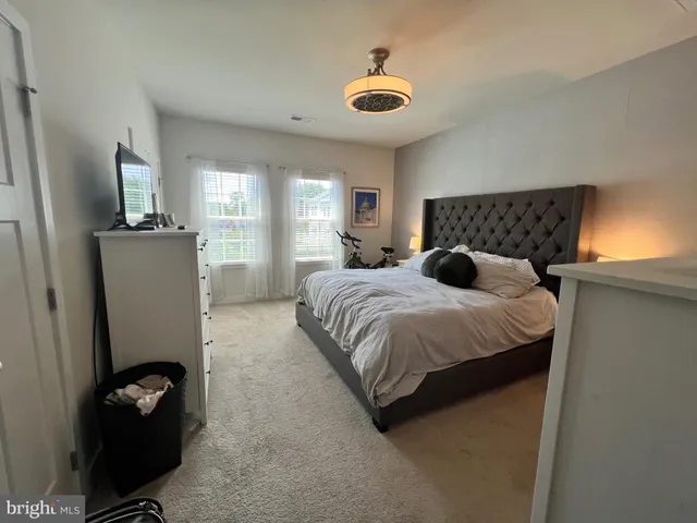 a bedroom with a bed and a flat tv screen on the wall