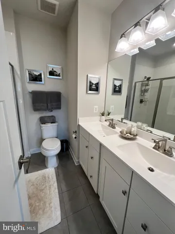 a spacious bathroom with a double vanity sink mirror and toilet