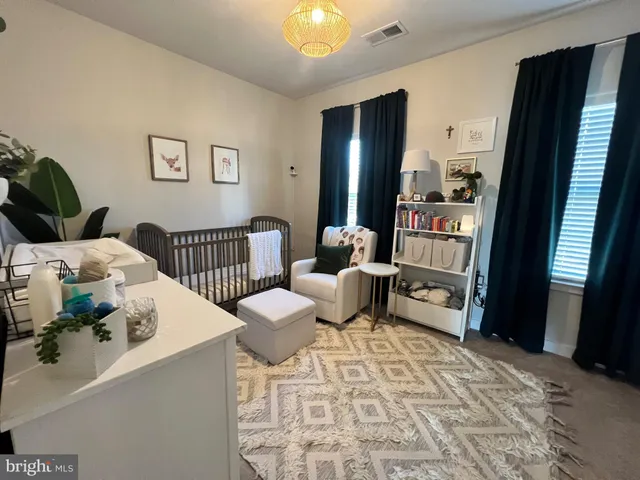 a bedroom with furniture and a rug