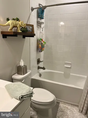 a bathroom with a sink a toilet and bathtub