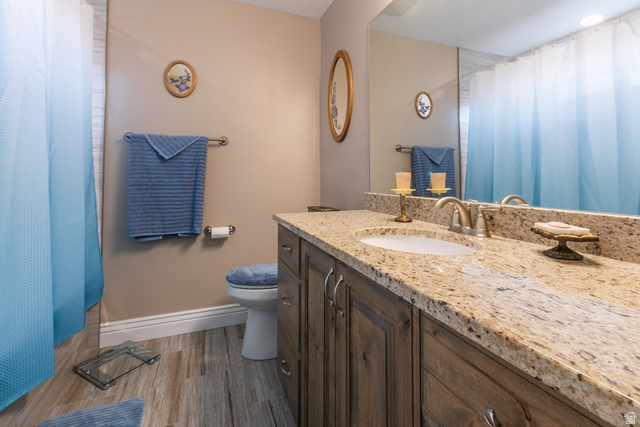 1228 North Providence Way Tooele, UT 84074 - Photo 16 of 28 Bathroom featuring a single vanity with a speckled countertop, a drop-in sink, and a brushed nickel faucet