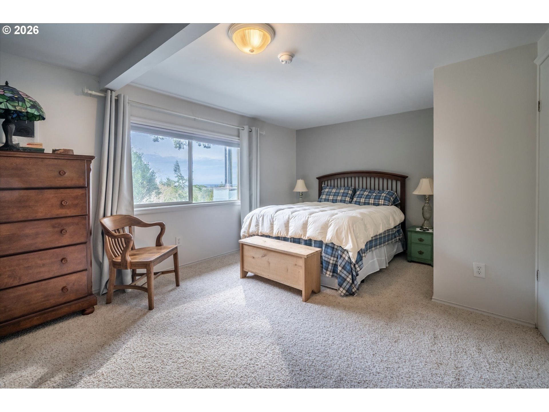42528 Hensley Hill Road Port Orford, OR 97465 - Photo 14 of 37 a spacious bedroom with a bed and a dresser