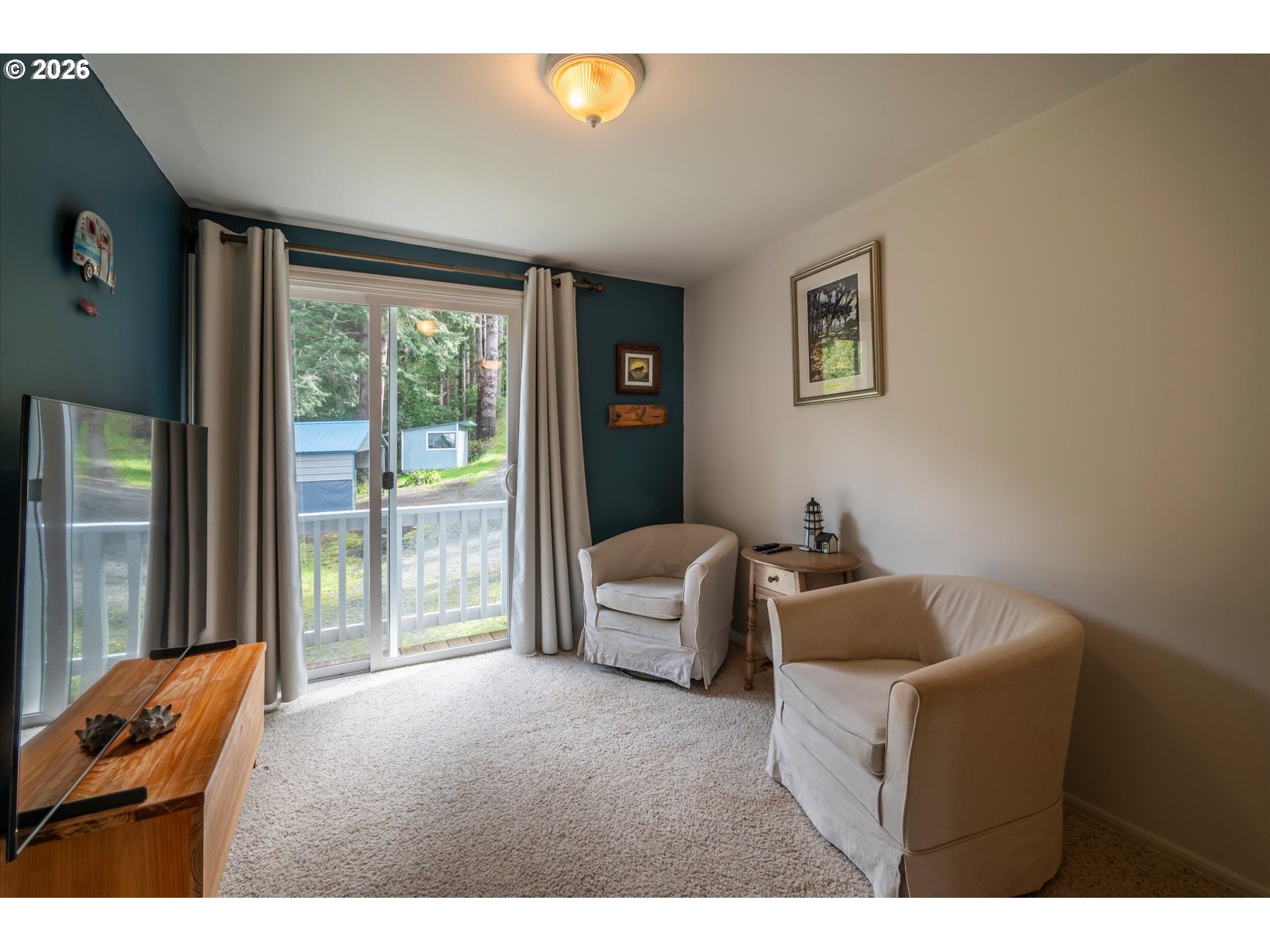 42528 Hensley Hill Road Port Orford, OR 97465 - Photo 16 of 37 a living room with furniture and a floor to ceiling window